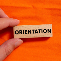 A tile with the word "orientation" on an orange background.