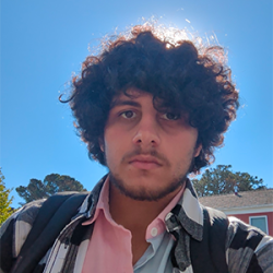 Headshot of Armin Abolhassani with the sun behind his head.