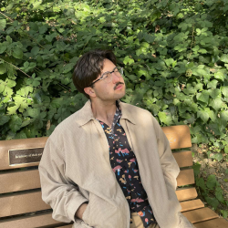 Photo of Xavier Berthon sitting on a bench.