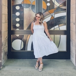 Image of Becca Cannon standing in a decorative doorway.
