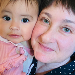 Jen smiling with her granddaughter.