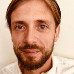 Headshot of Kris Kemtrup smiling.