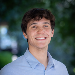 Photo of Miles Ozorio smiling.
