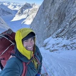 Headshot of Elias Spitulnik on a snowy mountainside.