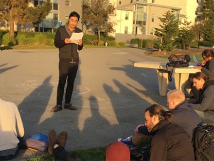 Student presenting outdoors.