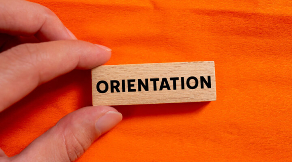 A tile with the word "orientation" on an orange background.
